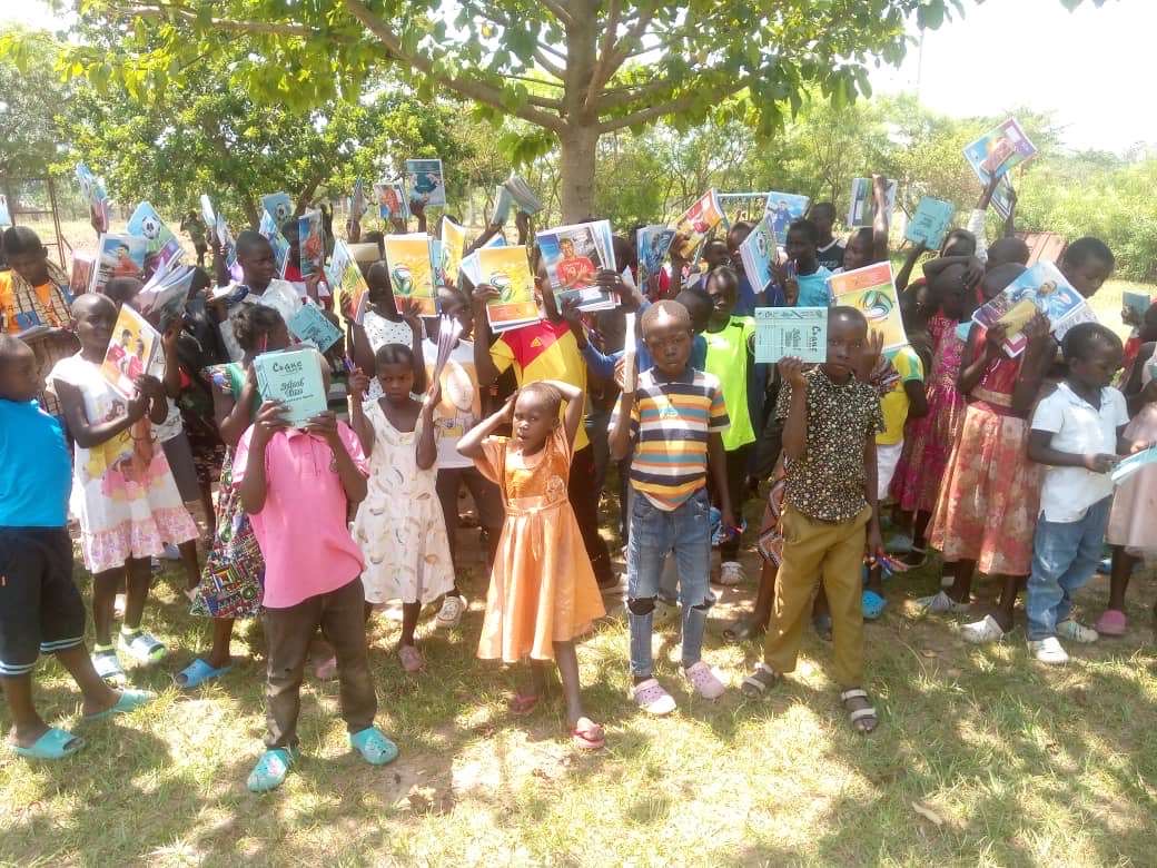 Children show their new exercise books at the start of the school year, Pochowa 2025.